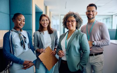 Group of happy entrepreneurs in business office looking at camera.
