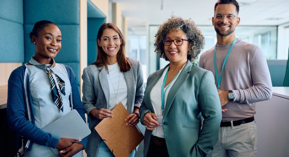 Group of happy entrepreneurs in business office looking at camera.